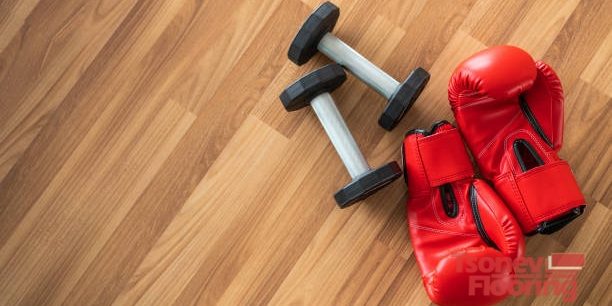 Red boxing gloves on wood background. Sport and healthy lifestyle concept.